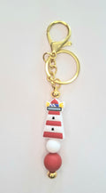 Porte clés, bijou de sac Perle Phare de Mer Rouge et Blanche